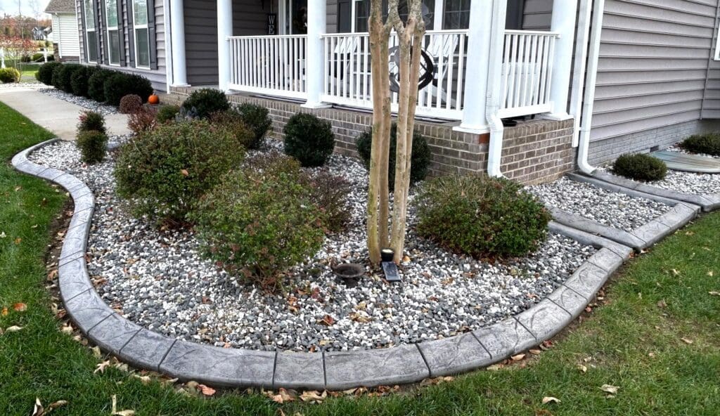 Decorative concrete curbing around garden bed in Great Falls VA home