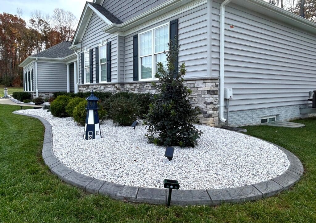 Concrete landscape edging with stone bed and plants in Great Falls VA
