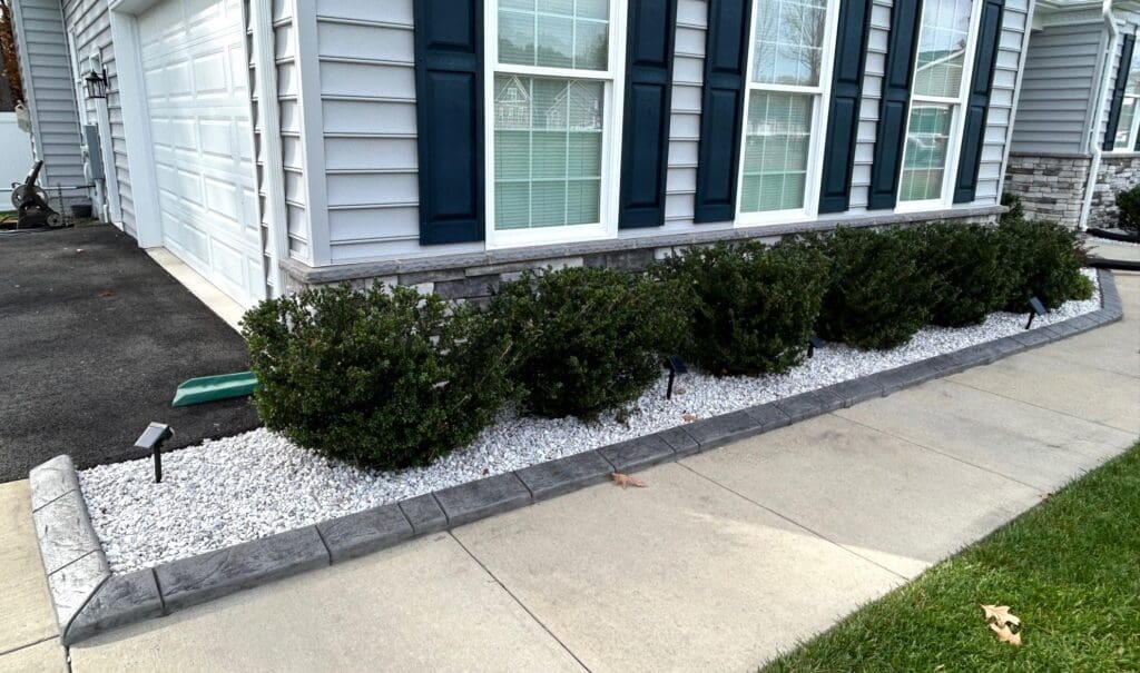 Decorative concrete landscape edging installed along driveway in Great Falls MD
