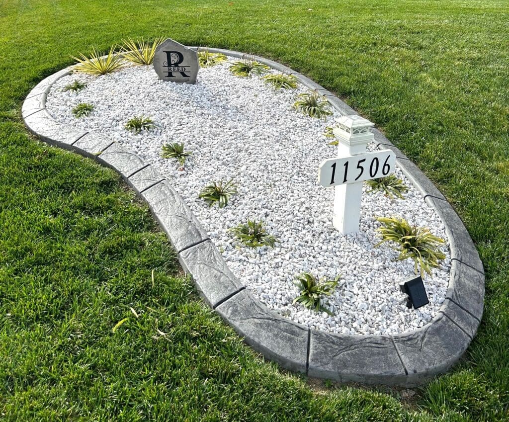 Concrete landscape edging around garden bed with stone fill in Fredericksburg VA