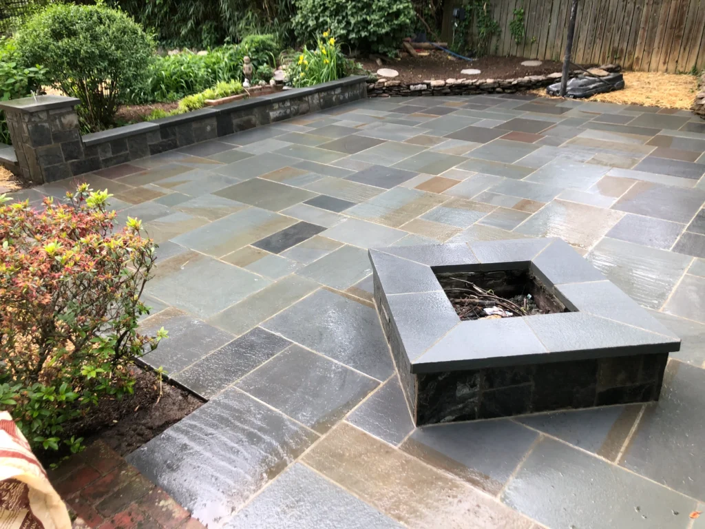 Stone patio with fire pit and clean landscape edging in Great Falls VA