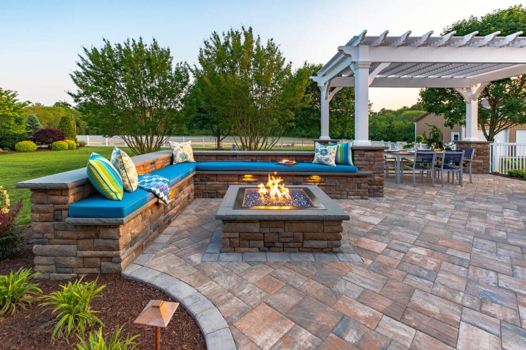 Backyard paver patio with outdoor seating and fire pit in Potomac, MD