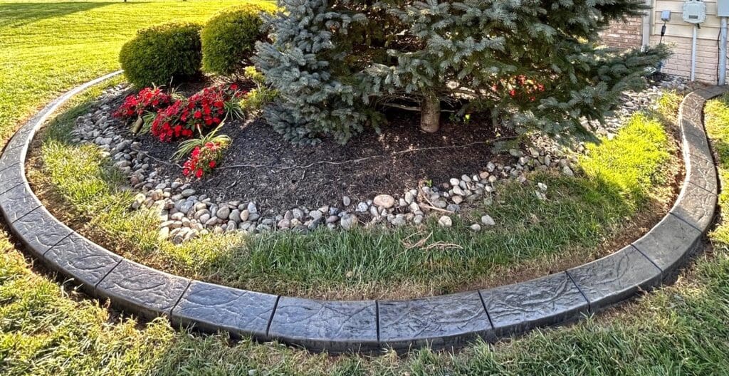 Decorative concrete curbing around a landscaped garden bed in Potomac MD