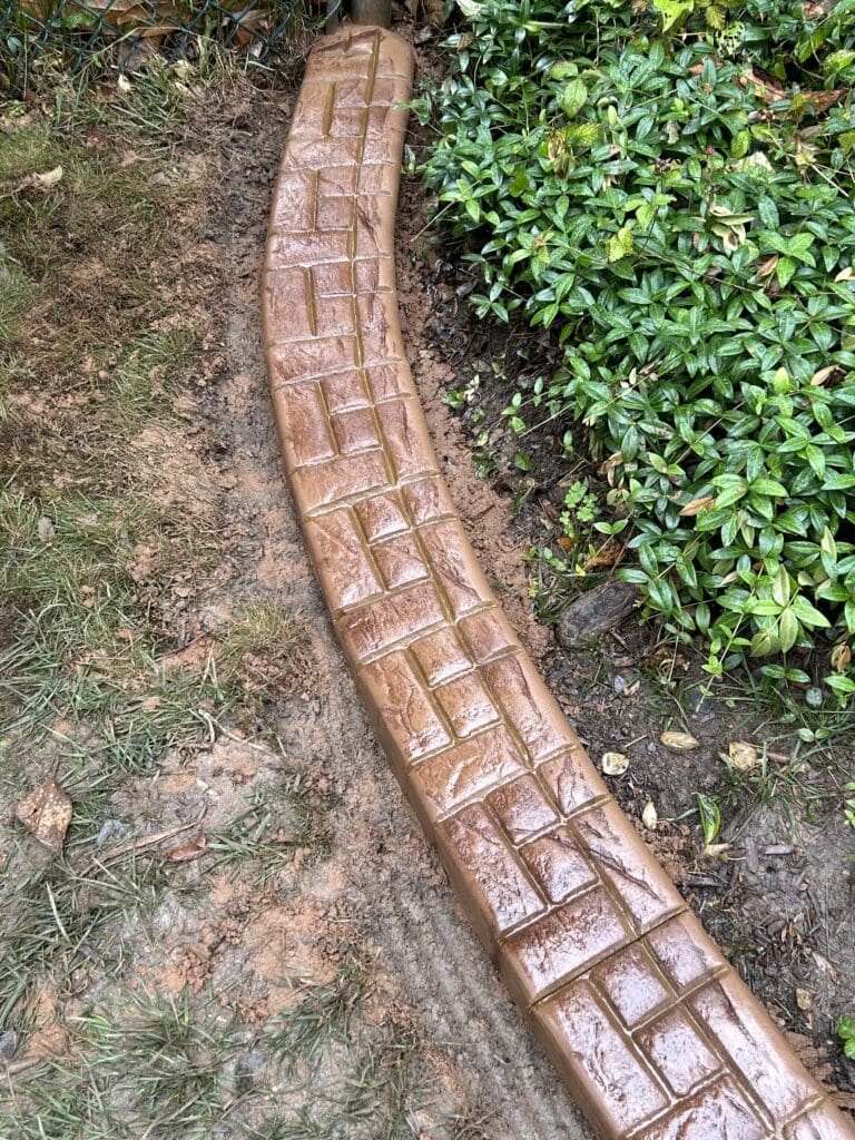 Decorative Concrete Curbing in Potomac, MD featuring a stamped Castlestone-12 pattern with a Greek key border detail.