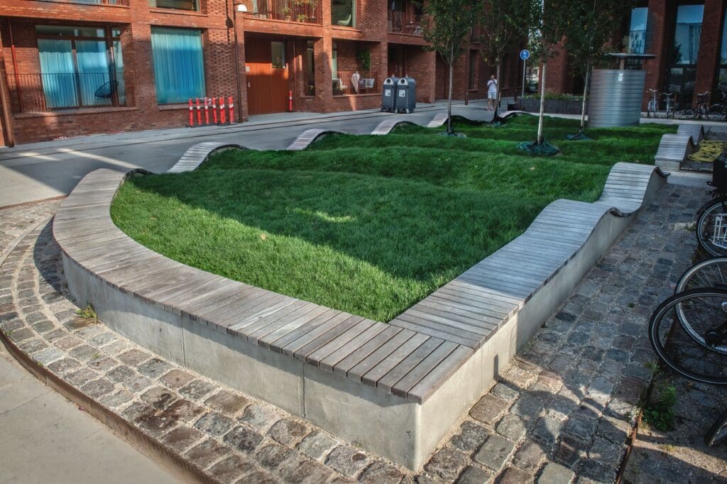 Decorative commercial concrete curbing around landscaped area near building entrance