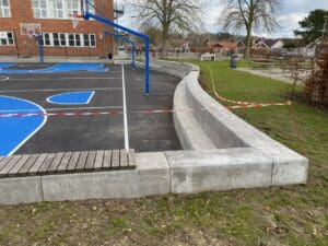 Concrete landscape edging around playground and walkway in Maryland